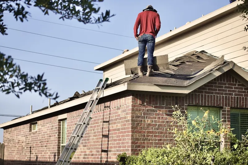 Professional roofer working on a residential roof in Cross Keys